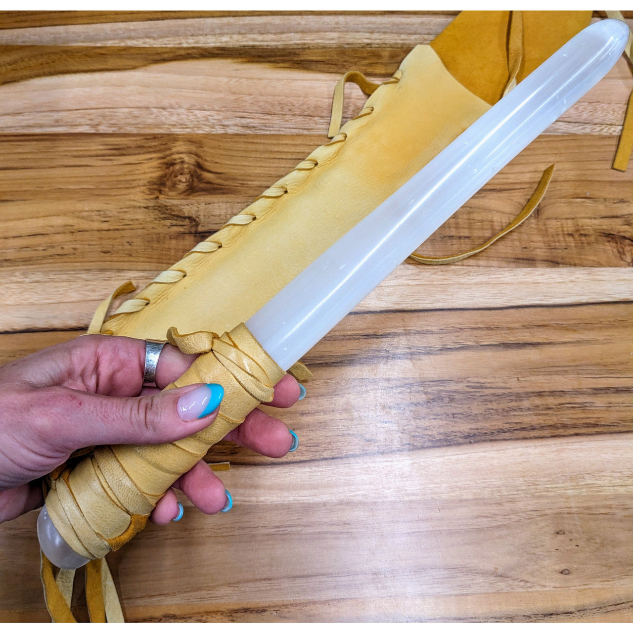 Person holding knife with deerskin leather handle and Shaman Selenite Wand #MJ03