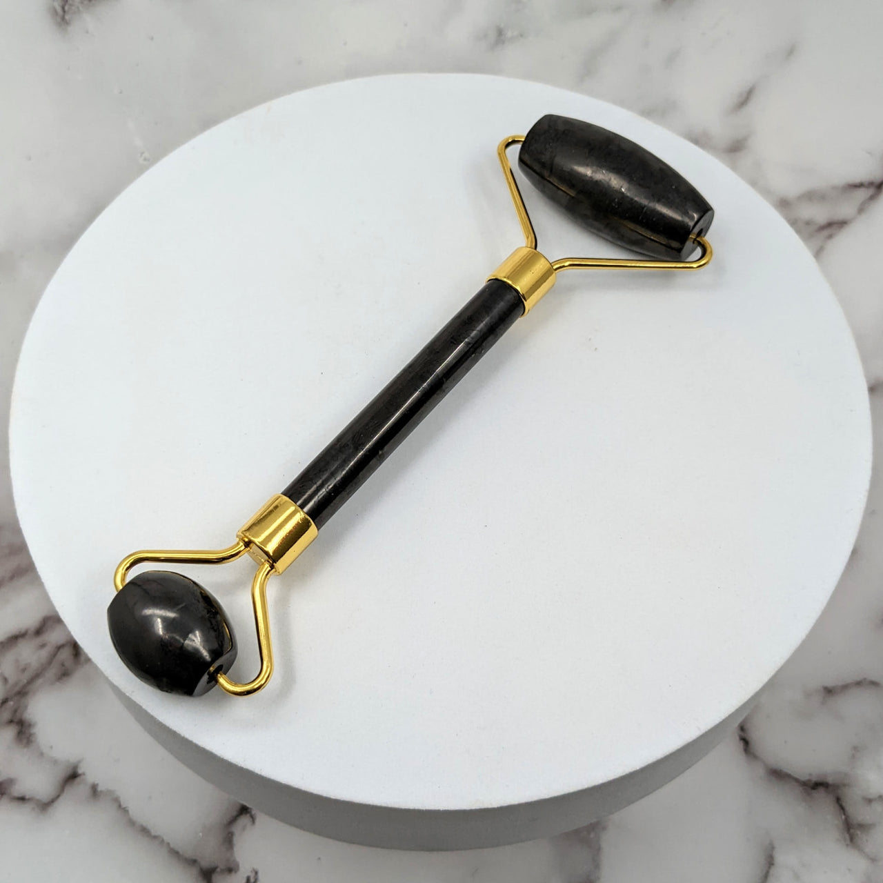 Elegant black and gold handled cane with marble handle - Shungite Facial Roller #LV1419