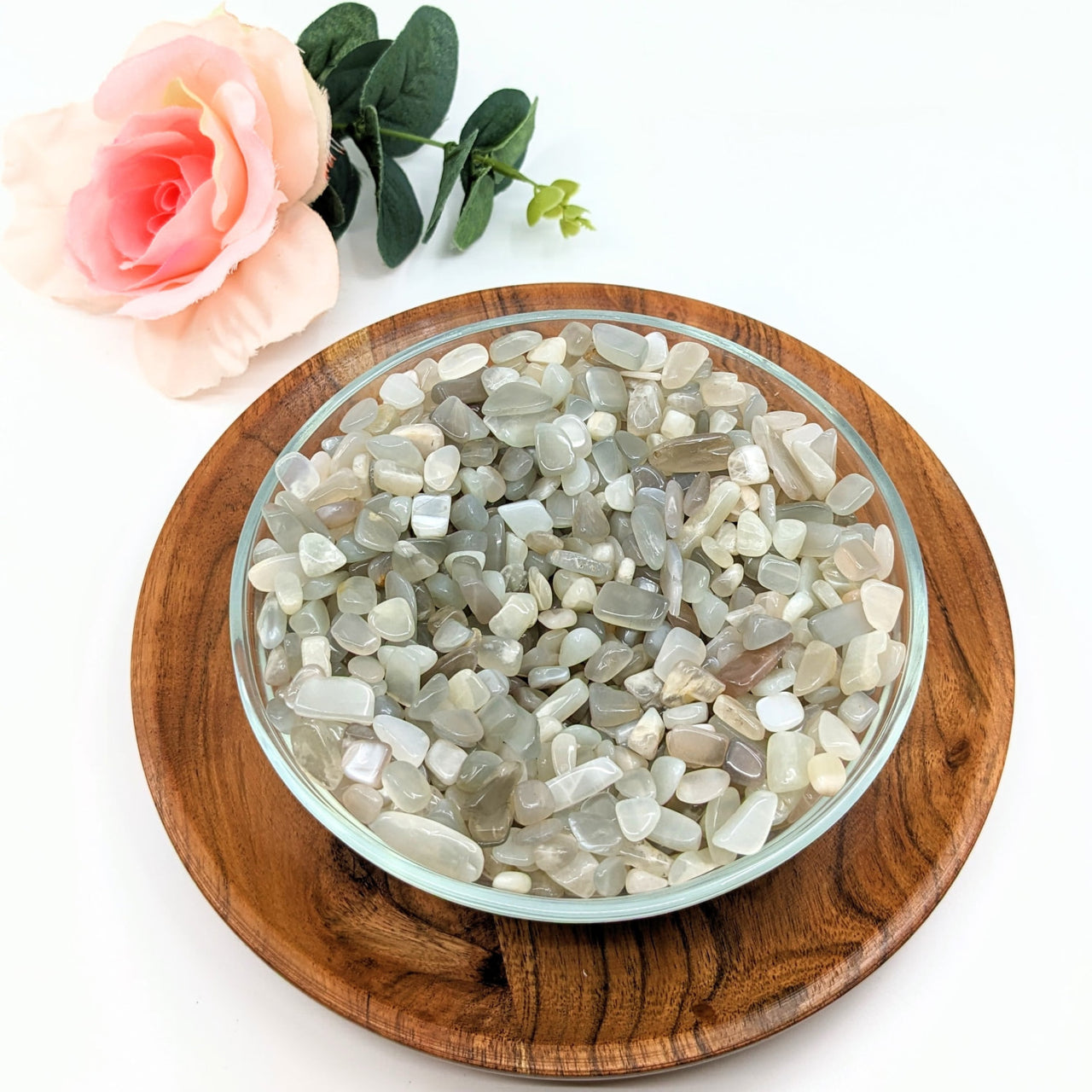 A bowl of Silver Moonstone Gravel Mini Chips on a wooden plate