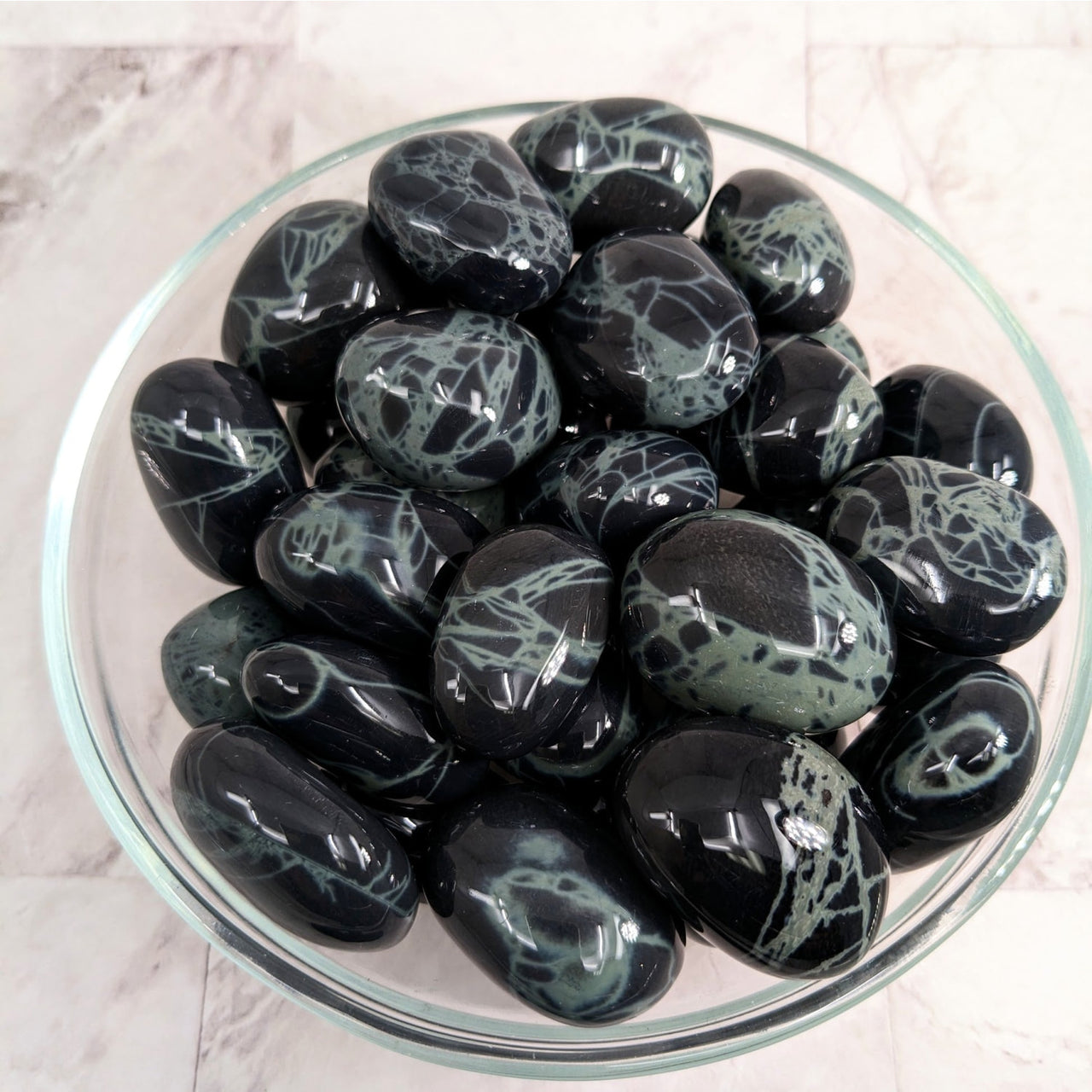 Bowl of colorful tumbled stones including Spider Web Obsidian Tumble Stone (1.2’) #LV2269