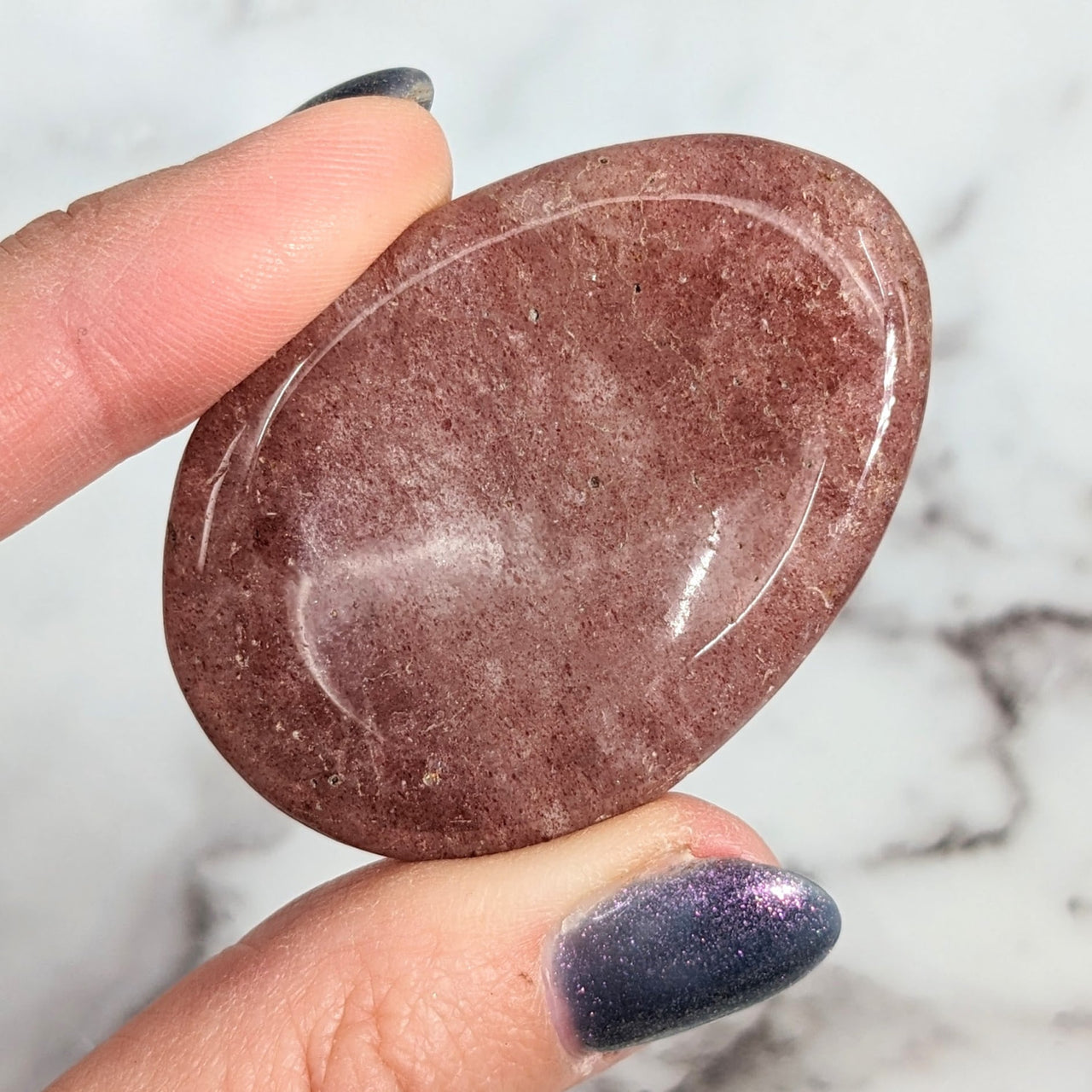 Person holding Strawberry Quartz 1.9’ - 2’ Thumb Stone #LV1930