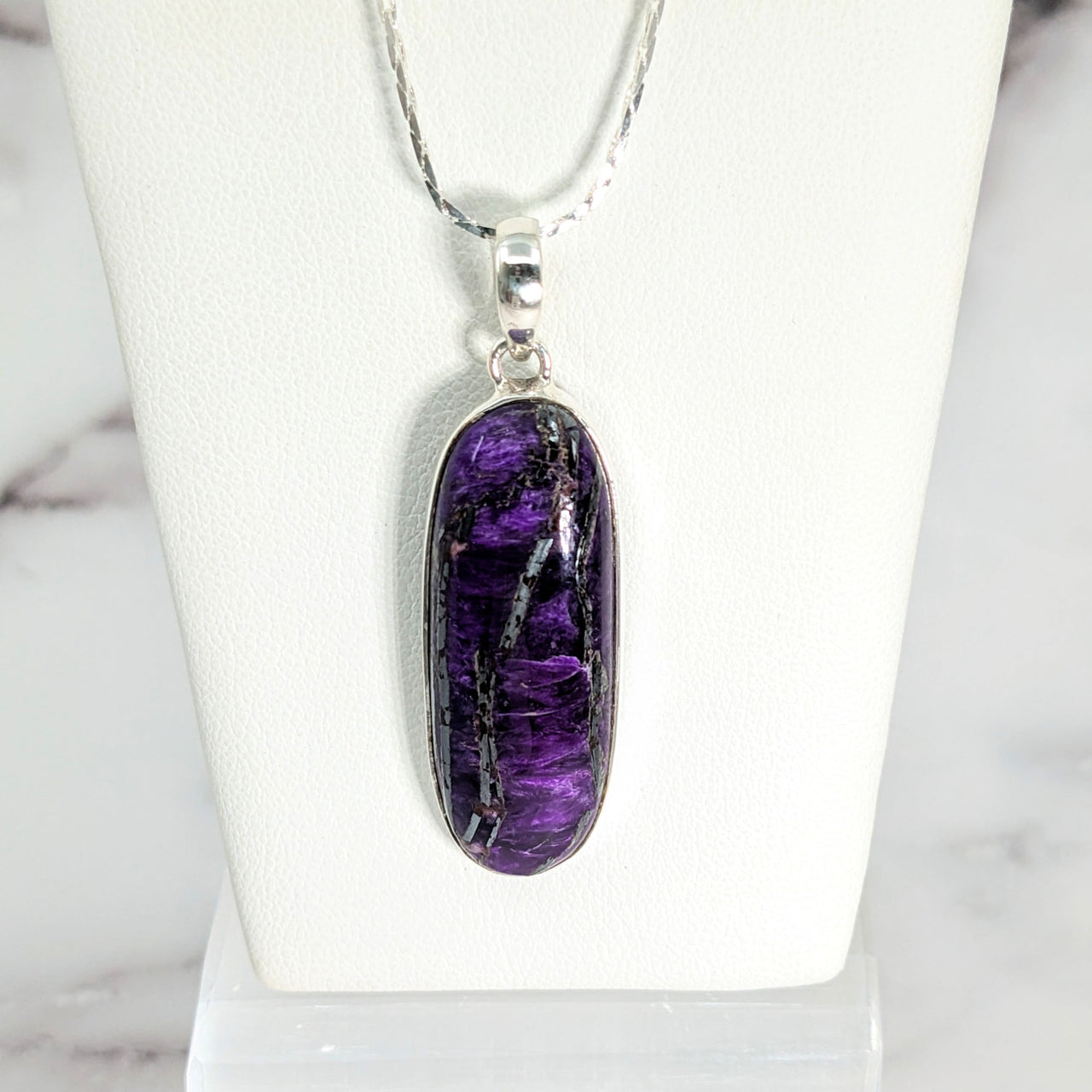 Sugilite 1.25’ Oval Pendant #LV2644 featuring an amethite pendant with sterling chain