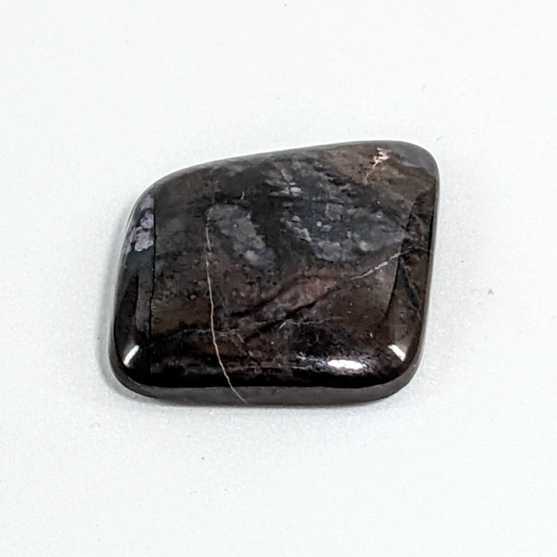 Sugilite Rectangle Cabochon #C138 - Elegant Black Stone on a Pristine White Surface