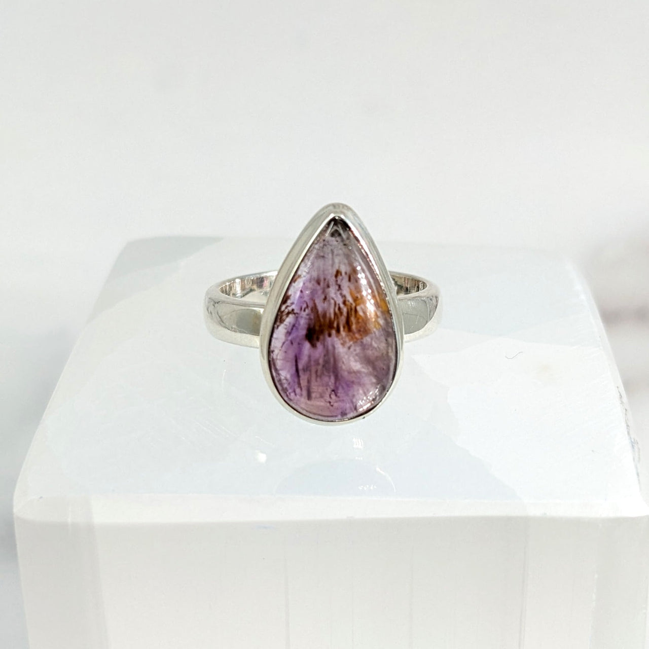 A large purple stone ring with a triangular face in ’Super 7 S.S. Teardrop Ring Sz. 7 #LV1734’