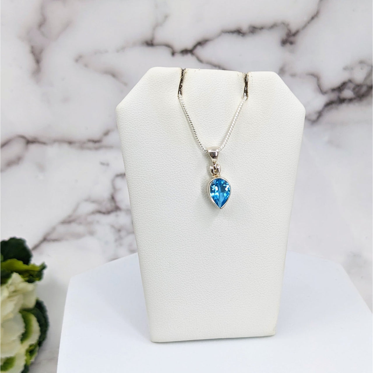 Swiss Blue Topaz Faceted Sterling Silver Pendant on White Stand - #LV3326