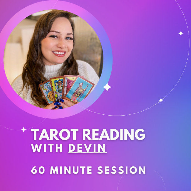 A girl holding a card that reads ’Tared with Devi’ for a Tarot Reading With Devin session