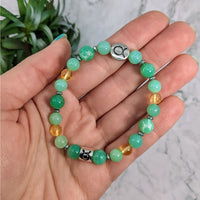 Thumbnail for Hand holding Taurus Zodiac Handmade Beaded Bracelet with green beads and silver clasp jewelry