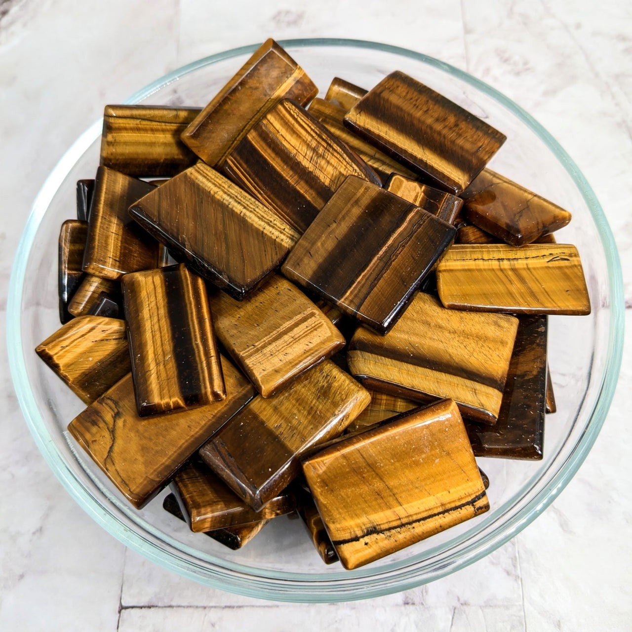 Bowl full of Tiger’s Eye gems in flat shape from Tiger’s Eye Gold Slab Slice (1-1.5’) #LV2253