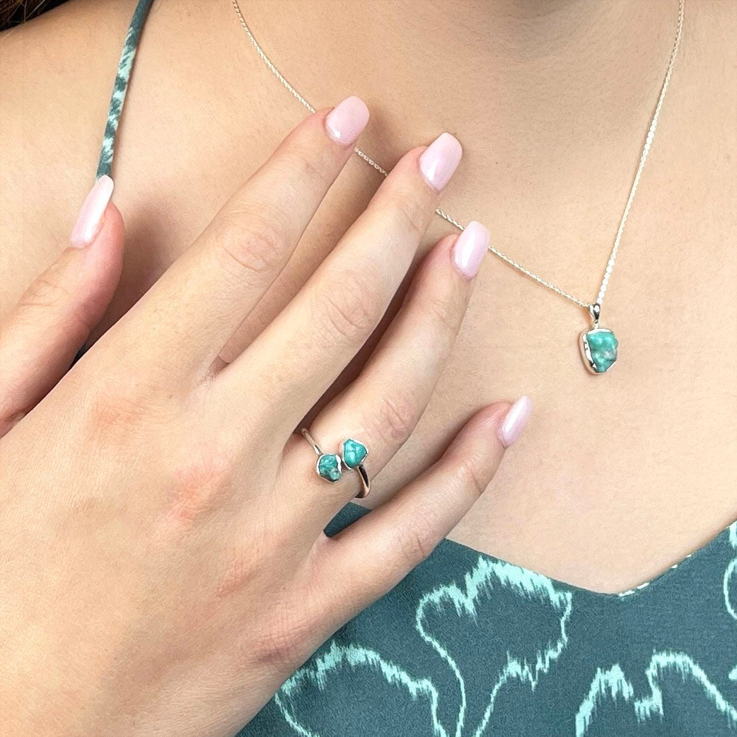 Woman wearing sterling silver turquoise ring and necklace from a crystal jewelry gift set