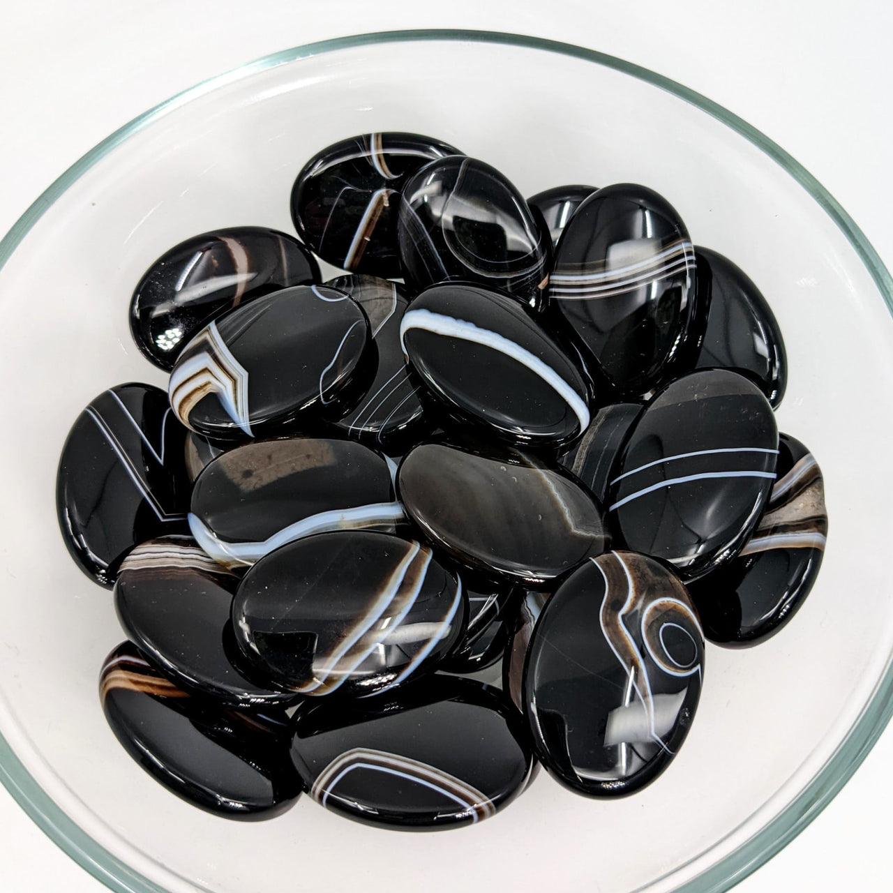 A bowl of black and white marbles; Tuxedo Agate Palm Stone (12g) #SK9002