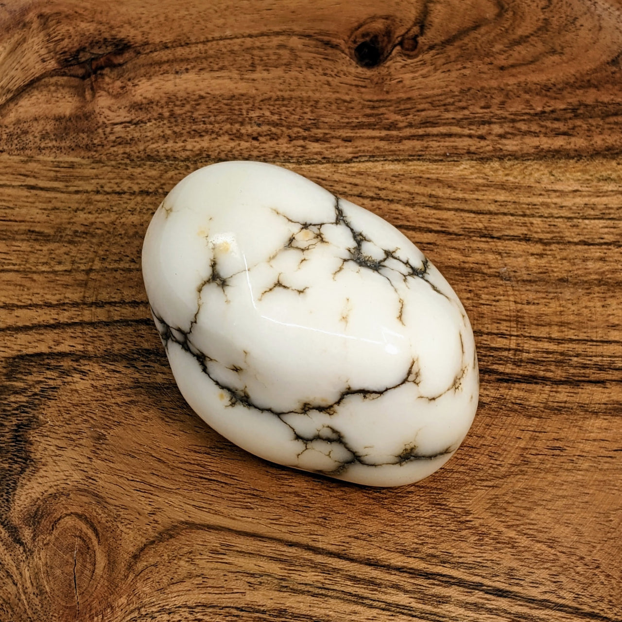 White Howlite Jumbo 2.7-inch Polished Nugget #LV2912 displayed on a wooden surface