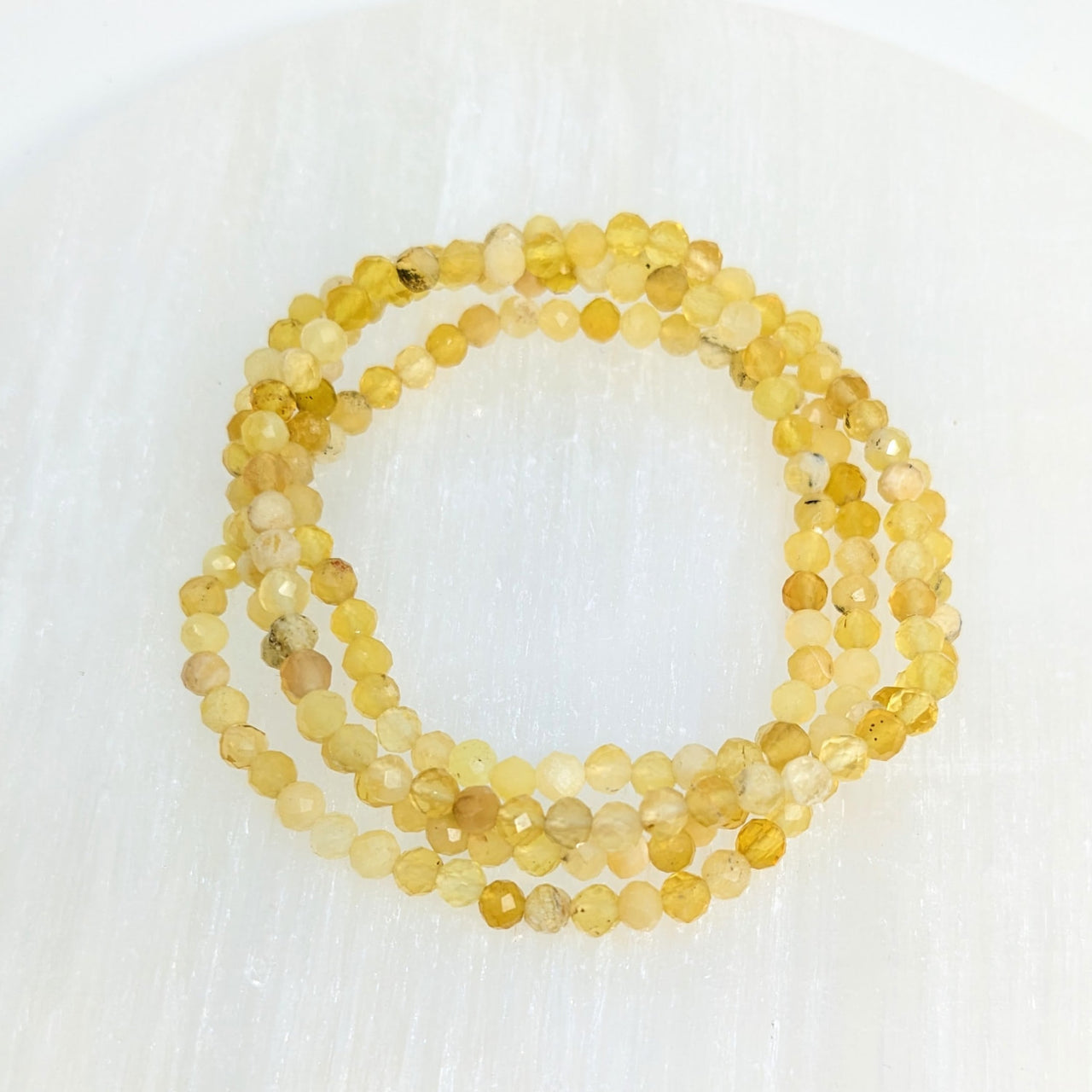 A yellow cinite bracelet with a gold clasp from the Yellow Opal 4 mm Faceted collection